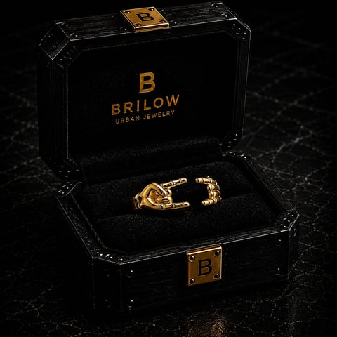 Gold knot ring displayed in open black Brilow Urban Jewelry box with gold branding on dark textured background