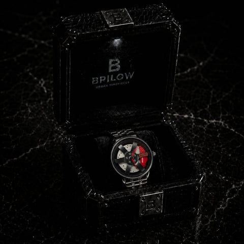 Luxury Bpilow chronograph watch with red and black dial displayed in black branded presentation box