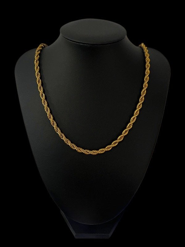 Gold twisted rope chain necklace displayed on a black mannequin bust against a black background
