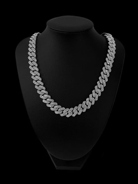 Diamond-studded tennis bracelet displayed in an arc against a black background