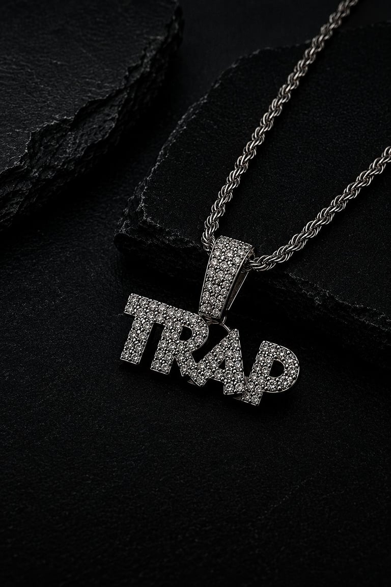 Silver TRAP pendant necklace with rhinestone bling on rope chain against dark textured background