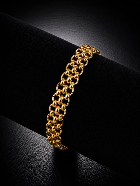 Gold chain bracelet with interlocking oval links displayed on black textured background