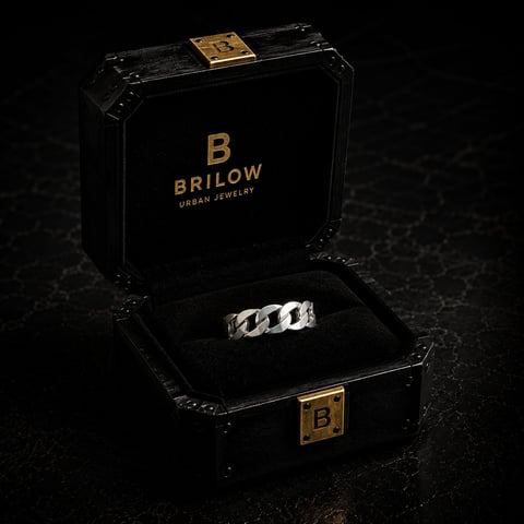 Silver chain link ring displayed in open black BRILOW Urban Jewelry box with gold logo on dark textured background