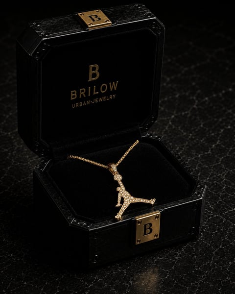 Gold pendant necklace displayed in open black Brilow Urban Jewelry luxury box with gold latch on dark surface