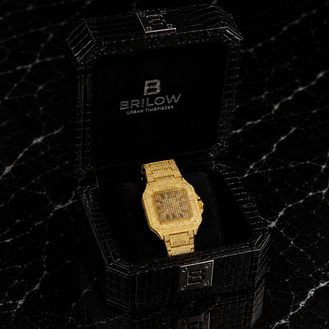 Gold-plated Brilow diamond digital watch displayed in black branded box on marble surface