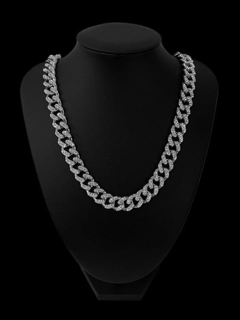 Silver diamond-studded Cuban link chain necklace displayed on a black mannequin bust