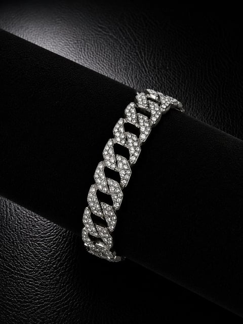 Diamond-encrusted curb chain bracelet displayed on black textured leather background in monochrome