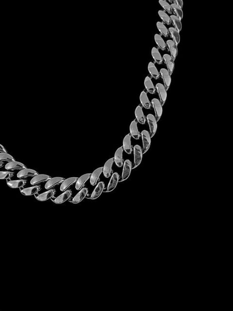 Silver chain necklace with interlocking links curved against a black background