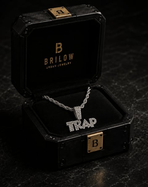 Black Brilow jewelry box with gold accents displaying a diamond pendant chain necklace with TRAP lettering