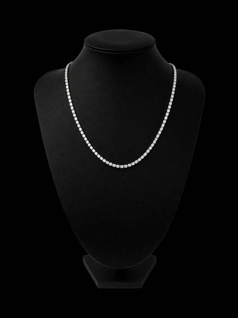 Gold diamond tennis necklace displayed on a black mannequin bust against a dark background